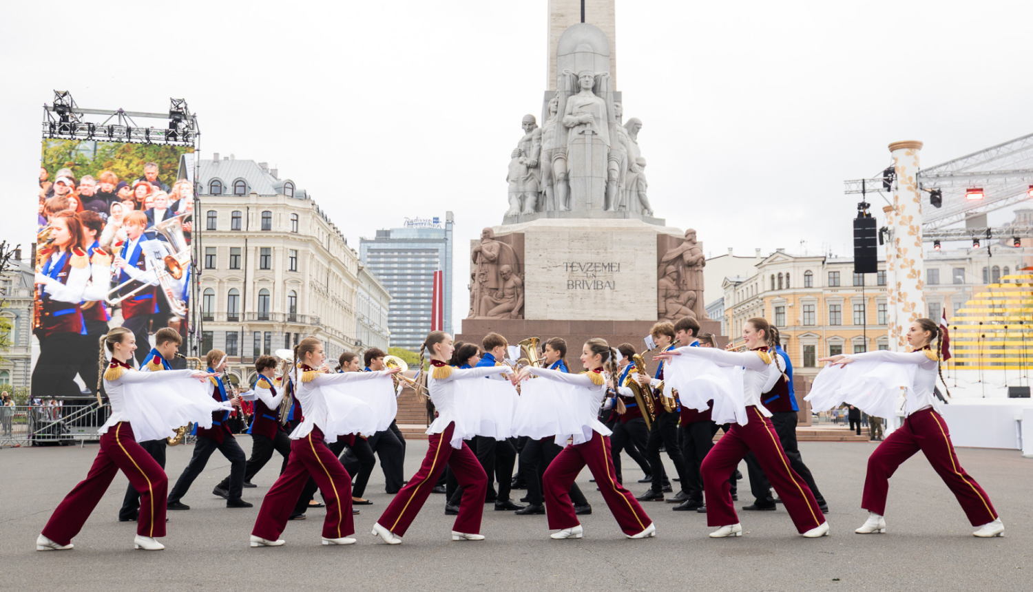 attēlā dalībnieki piedalās Latvijas skolēnu pūtēju orķestru defile pie Brīvības pieminekļa
